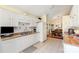 Well-lit kitchen equipped with white appliances and cabinets, seamlessly connected to the dining area at 9011 Brad Ct, Matthews, NC 28104