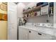 Practical laundry room with a washer, dryer, and ample shelving for storage at 9011 Brad Ct, Matthews, NC 28104