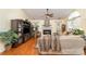 Cozy living room featuring a fireplace, hardwood floors, and a ceiling fan for added comfort at 9011 Brad Ct, Matthews, NC 28104