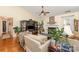 Bright living room with a vaulted ceiling, fireplace, hardwood floors, and large windows at 9011 Brad Ct, Matthews, NC 28104