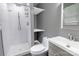 Bathroom features a tiled shower, open shelving, modern sink and gray walls at 102 Central Ave, Bessemer City, NC 28016