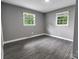 Bright bedroom with two windows and hardwood floors at 102 Central Ave, Bessemer City, NC 28016