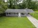 Charming one-story home with a well-maintained lawn and a covered carport at 102 Central Ave, Bessemer City, NC 28016