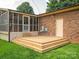 Spacious backyard with a wooden deck and screened in back porch at 10728 Forest Dr, Matthews, NC 28105