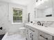 Light-filled bathroom with marble tiles, sleek vanity, and modern fixtures at 10728 Forest Dr, Matthews, NC 28105