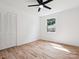 Bright bedroom with hardwood floors, white walls, closet, and a window at 10728 Forest Dr, Matthews, NC 28105