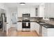 Modern kitchen with stainless steel appliances, granite countertops, and shaker cabinets at 10728 Forest Dr, Matthews, NC 28105