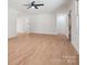 Bright and airy living room featuring hardwood floors, ceiling fan, and neutral paint at 10728 Forest Dr, Matthews, NC 28105