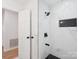 Modern shower with black accents, glass partition, and white marble-style tile at 10728 Forest Dr, Matthews, NC 28105