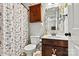 Charming bathroom with seashell decor, vanity storage and a shower with patterned curtain at 112 E Heart Pine Ln, Statesville, NC 28677