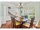 Formal dining room with large table, chairs, hardwood flooring, and natural lighting at 112 E Heart Pine Ln, Statesville, NC 28677