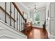 Elegant foyer with hardwood floors, staircase, and natural light from a large window at 112 E Heart Pine Ln, Statesville, NC 28677