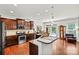 Open kitchen with granite countertops, stainless steel appliances, and hardwood flooring at 112 E Heart Pine Ln, Statesville, NC 28677