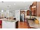 Well-equipped kitchen featuring stainless steel appliances, granite countertops, and dark wood cabinetry at 112 E Heart Pine Ln, Statesville, NC 28677