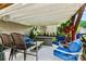 Cozy covered patio with white ceiling, comfortable seating, and decorative plants for relaxation at 112 E Heart Pine Ln, Statesville, NC 28677