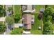 Aerial view of home showing well-manicured lawn, driveway, landscaping, and fenced backyard at 11834 Planters Estates Dr, Charlotte, NC 28278