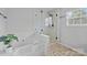 Bright bathroom features a modern glass-enclosed shower and a separate bathtub with a tiled surround at 11834 Planters Estates Dr, Charlotte, NC 28278