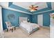 Bright and inviting bedroom features a trey ceiling, neutral carpet, and a plush, upholstered bed at 11834 Planters Estates Dr, Charlotte, NC 28278