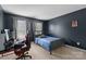 Bedroom with blue wall, gaming setup and large window offers a comfortable living space at 11834 Planters Estates Dr, Charlotte, NC 28278