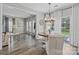Bright dining area with wood floors, modern chandelier, and sliding glass doors to the backyard at 11834 Planters Estates Dr, Charlotte, NC 28278