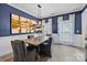 Stylish dining room with blue walls, modern lighting, and elegant decor at 11834 Planters Estates Dr, Charlotte, NC 28278