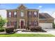 Charming two-story brick home with a well-manicured lawn and inviting red door and red shutters at 11834 Planters Estates Dr, Charlotte, NC 28278