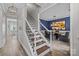 Inviting hallway with hardwood floors leading to a dining room with a blue accent wall at 11834 Planters Estates Dr, Charlotte, NC 28278