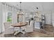 Charming eat-in kitchen with white cabinets, modern appliances, and a cozy breakfast nook at 11834 Planters Estates Dr, Charlotte, NC 28278