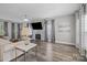 Comfortable living space with a stone accent wall, modern decor, and ample seating at 11834 Planters Estates Dr, Charlotte, NC 28278