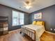 Charming bedroom with a metal frame bed, natural light, and stylish shelving for storage at 120 Prairie View Ct, Belmont, NC 28012