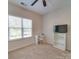 Bedroom with neutral carpet, window, ceiling fan, desk and bookcase at 120 Prairie View Ct, Belmont, NC 28012