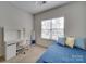 Bedroom with blue bedspread, neutral carpet and a desk by the window at 120 Prairie View Ct, Belmont, NC 28012