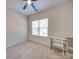 Neutral carpeted bedroom featuring a ceiling fan, a window with blinds, and a white desk with chair at 120 Prairie View Ct, Belmont, NC 28012