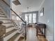 Staircase leading to dining room and kitchen with hardwood floors at 120 Prairie View Ct, Belmont, NC 28012