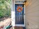Inviting front door with seasonal wreath, covered porch, and well-maintained exterior at 120 Prairie View Ct, Belmont, NC 28012