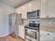 Modern kitchen with stainless steel appliances, granite counters, and white cabinets for a clean, updated look at 120 Prairie View Ct, Belmont, NC 28012