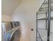 Laundry area with gray washer, storage shelf and sloped ceiling at 120 Prairie View Ct, Belmont, NC 28012