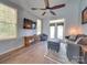 Cozy living room featuring hardwood floors, ceiling fan, and access to the outdoor space at 120 Prairie View Ct, Belmont, NC 28012