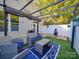 Inviting backyard patio with comfortable seating under a pergola, enhanced by artificial turf and a privacy fence at 120 Prairie View Ct, Belmont, NC 28012