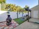 Cozy backyard patio featuring a pergola, artificial turf, privacy fence, and a rustic fire pit at 120 Prairie View Ct, Belmont, NC 28012