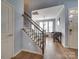 Open staircase with hardwood floors, decorative chandelier, and stylish banister at 120 Prairie View Ct, Belmont, NC 28012