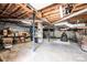 Spacious unfinished basement with concrete floor, exposed pipes, and brick support beams offers ample storage at 1211 25Th Se St, Hickory, NC 28602