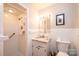 Updated bathroom with a tiled shower, marble sink, and modern fixtures providing a clean, fresh look at 1211 25Th Se St, Hickory, NC 28602