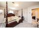 Comfortable bedroom featuring a four-poster bed, neutral carpeting, and a wheelchair, offering accessibility at 1211 25Th Se St, Hickory, NC 28602