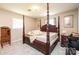 The room has a grand four-poster bed, carpet and side table for relaxation in a serene space at 1211 25Th Se St, Hickory, NC 28602