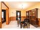 Traditional dining room with wood paneling, wallpaper, a black dining set, and vintage charm at 1211 25Th Se St, Hickory, NC 28602