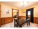 Charming dining room featuring wood paneling, wallpaper, a chandelier, and an open view to the living room at 1211 25Th Se St, Hickory, NC 28602