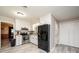 Bright kitchen featuring white cabinets, stainless steel appliances, and a black refrigerator, complemented by light gray floors at 1211 25Th Se St, Hickory, NC 28602