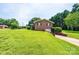 Brick home with a sprawling lawn and convenient drive-under garage at 1211 25Th Se St, Hickory, NC 28602