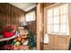 Cluttered storage room with wood-paneled walls, assorted boxes and objects, and a vintage sink at 1211 25Th Se St, Hickory, NC 28602